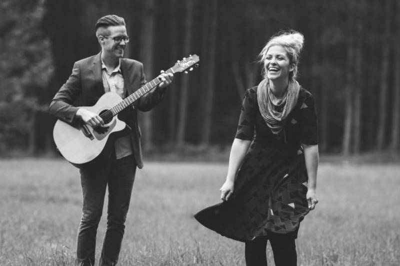 Oh Brother Big Sister strolling along on a nice day, with a guitar.